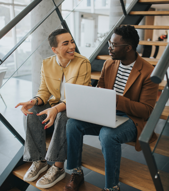 Two people with laptops